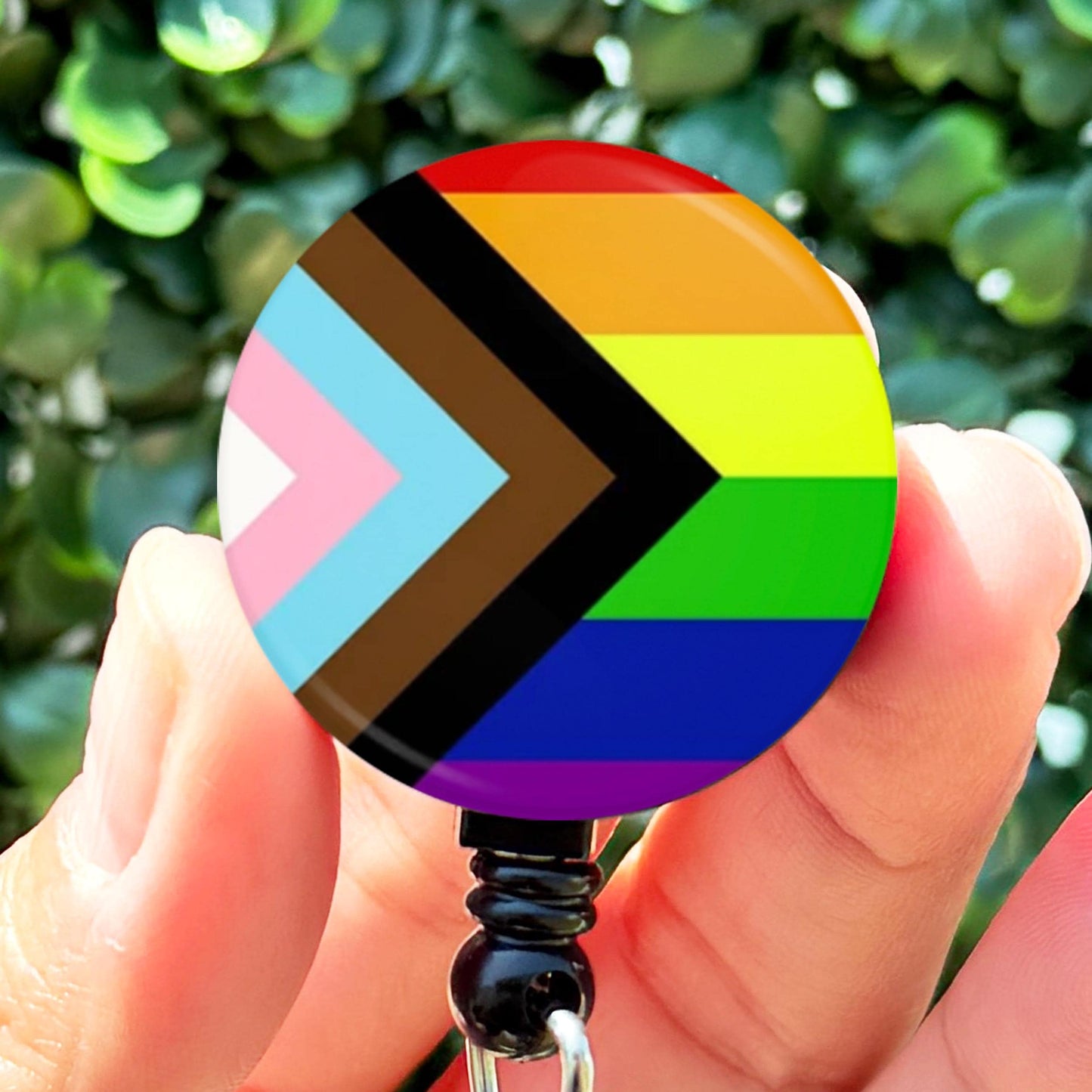 a person holding a colorful badge in their hand