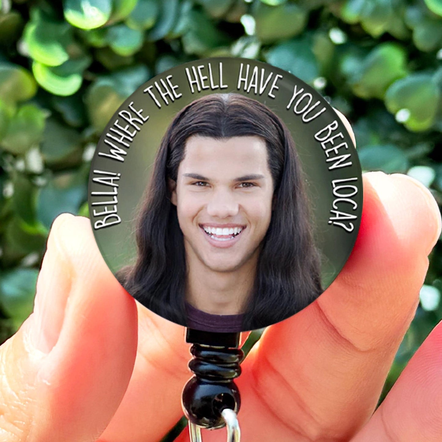 a person holding a badge with a picture on it