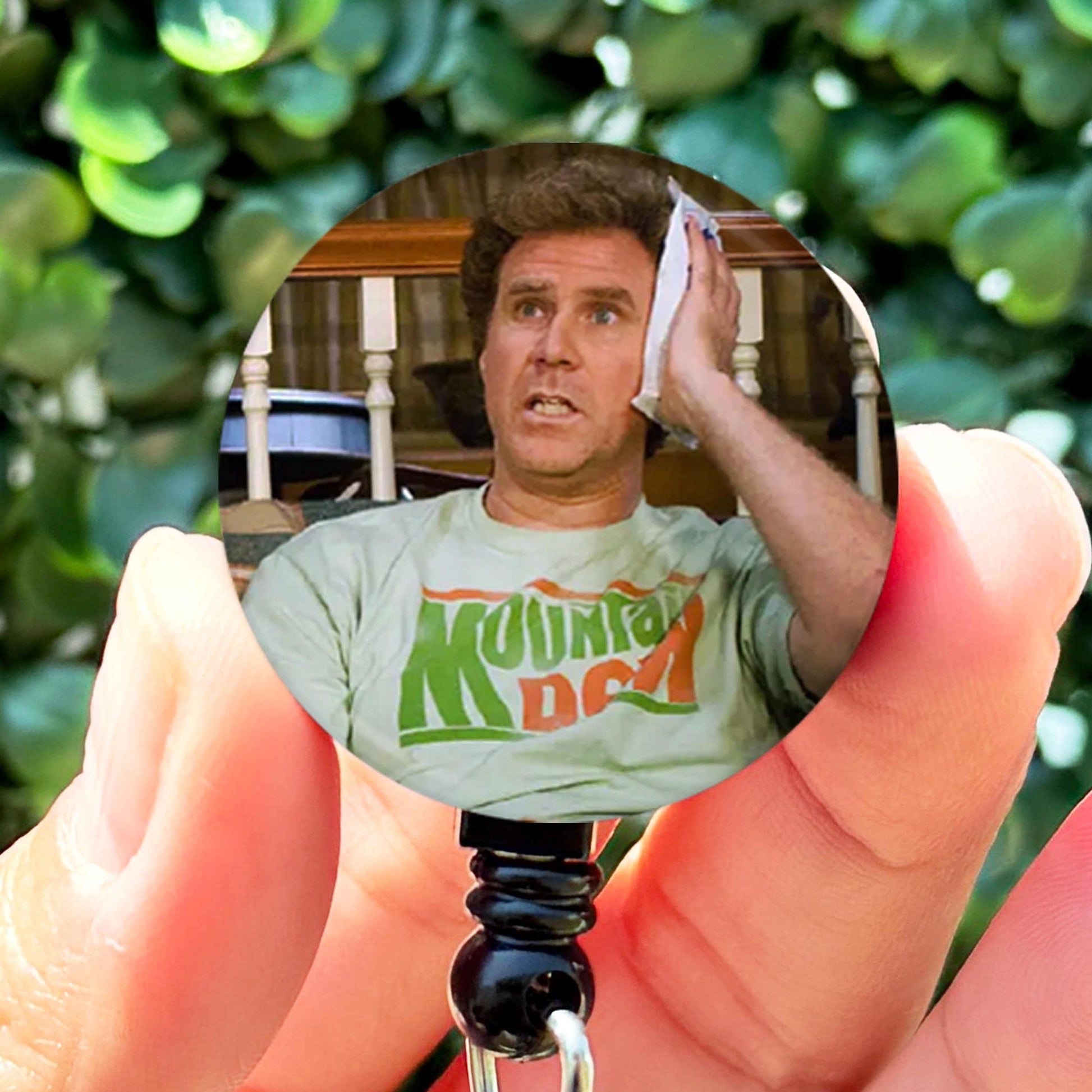 a hand holding a small picture of a man