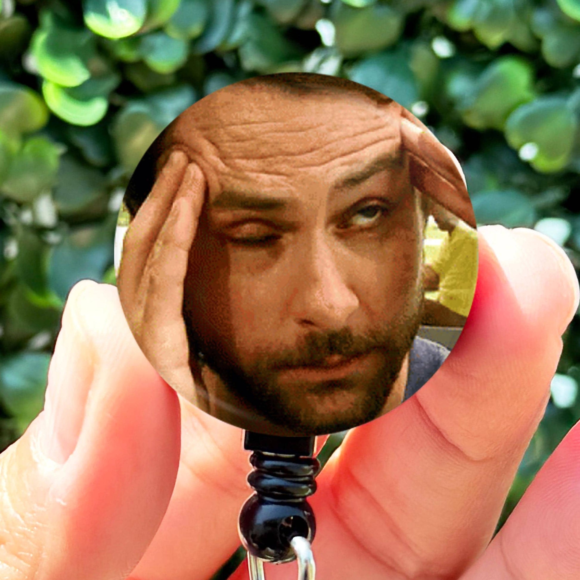 a man holding a cell phone up to his face