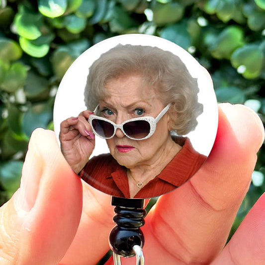 a person holding a camera with a picture of an old woman in it